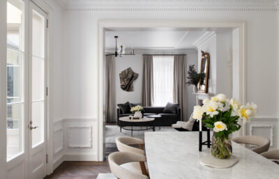 Elegant Melbourne living and dining room with marble surfaces, neutral palette, and modern furnishings.