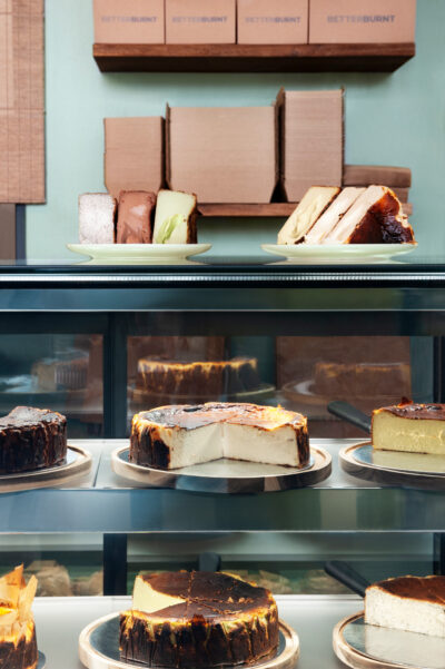 Display of Basque cheesecakes in glass counter at Better Burnt café in Hawthorn.