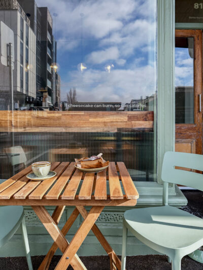 Outdoor café seating with sage green chairs and timber tables outside Better Burnt Hawthorn