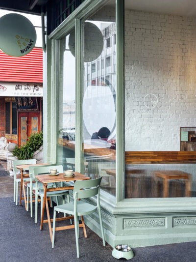 Outdoor seating with green chairs and timber tables outside Better Burnt café Hawthorn.