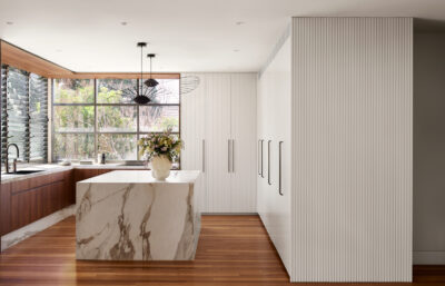 Contemporary Australian kitchen with marble island, timber cabinetry, and modern lighting.