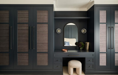A custom wardrobe and vanity with architectural detailing in a modern Sydney bedroom.