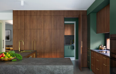 Modern kitchen with timber joinery and green cabinetry, showcasing quality interior design.