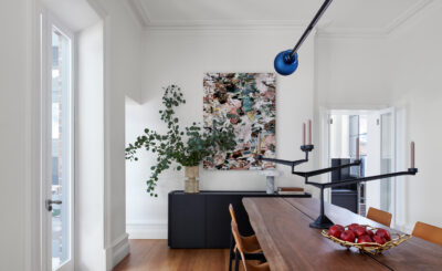 Modern Australian dining room with timber table, leather chairs, and abstract artwork.