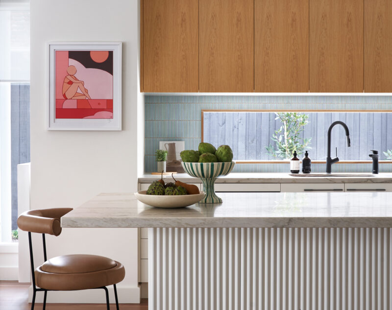 Modern Australian kitchen with marble island, timber cabinetry, and fluted detailing