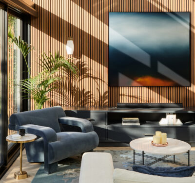 Australian living room with timber slatted wall, modern armchair, and layered natural light.