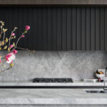Contemporary kitchen with marble benchtop, black cabinetry, and pink floral styling.