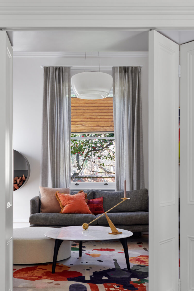 Mid-century inspired living room with earthy tones, sculptural furniture, and modern art.