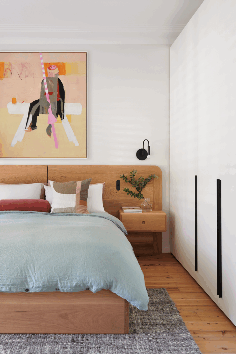 Scandinavian bedroom with light timber bed, soft neutral bedding and minimalist styling in Richmond, Melbourne by The Stylesmiths.