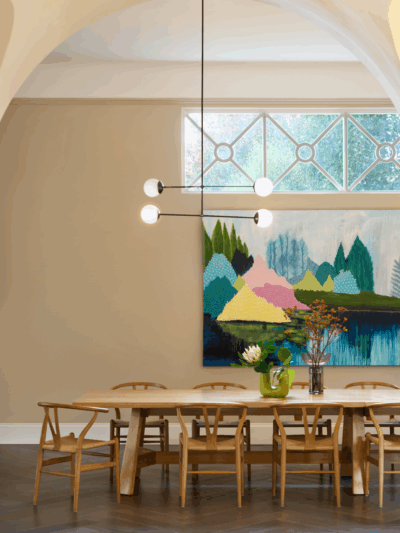 Scandinavian-style breakfast nook with soft neutral tones, curved architecture and natural timber detailing in a Richmond home by The Stylesmiths.