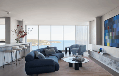 Light-filled contemporary apartment living room in Sydney by The Stylesmiths with sculptural furniture and coastal views.