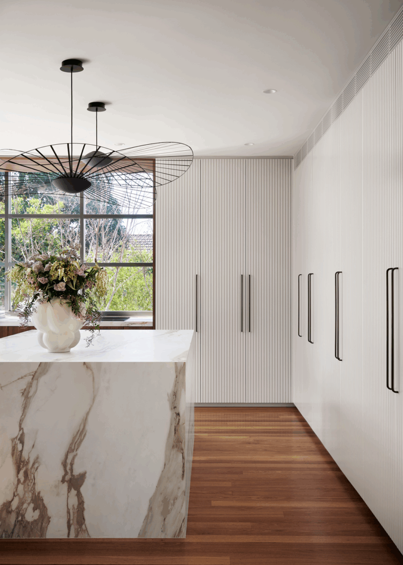 Contemporary kitchen in Sydney by The Stylesmiths featuring sculptural joinery, marble island and refined modern finishes.
