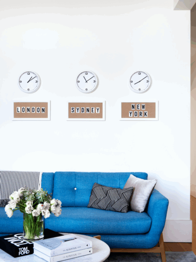 Hamptons style office interior in Melbourne by The Stylesmiths featuring a coastal blue sofa, crisp white walls and relaxed refined styling