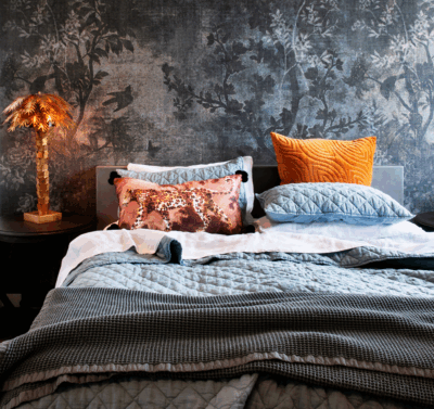 Moody luxury bedroom interior in Brisbane with layered textiles and statement lighting by The Stylesmiths