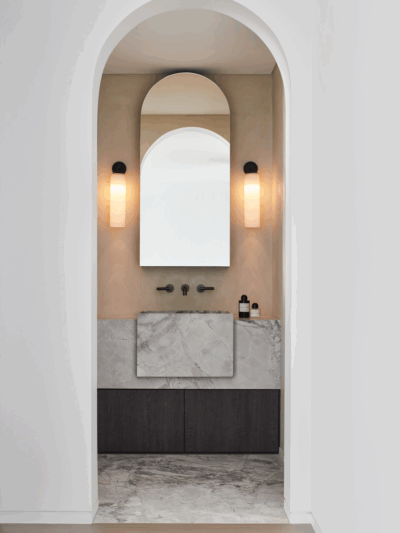 Luxury Sydney bathroom by The Stylesmiths featuring an arched vanity, marble finishes and soft modern tones.